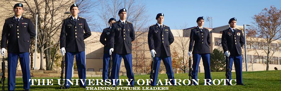 Cadets in uniform stand at attention on The University of Akron campus