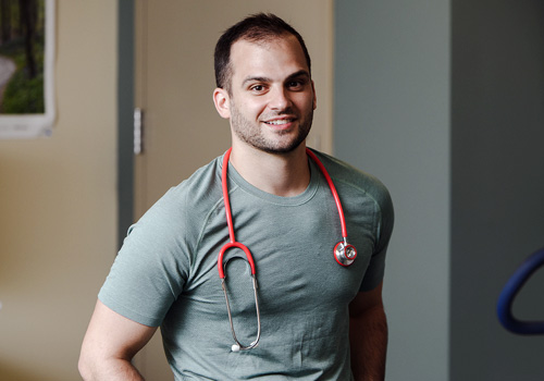 Male student with stethoscope around his neck