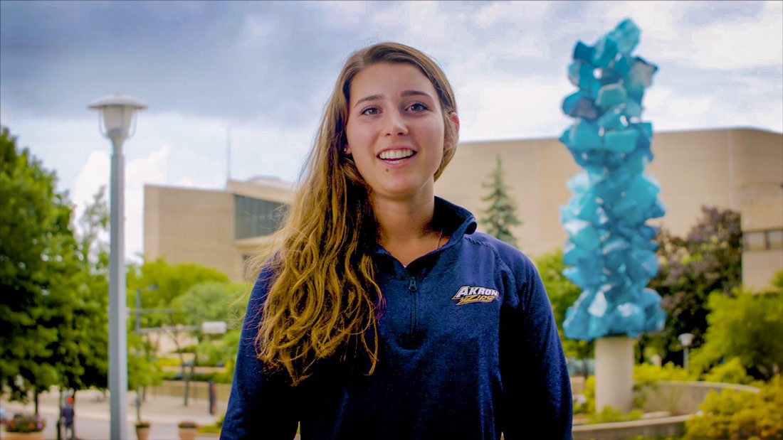 Emma Harmon outside the Goodyear Polymer Building on The University of Akron campus