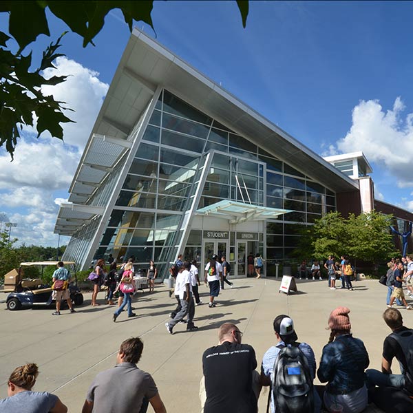 Students gather near the modern-looking Student Center in the center of campus.