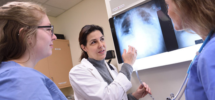 A faculty member in the Respiratory Therapy degree program at The University of Akron interprets a medical test with students