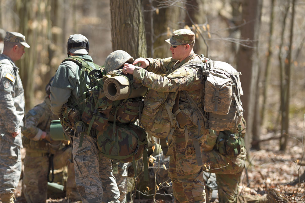 A student assists a teammate in conducting pre-execution checks