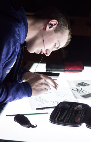 An undergraduate art major works at a light table.