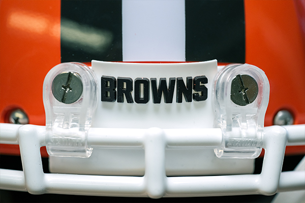 Close-up of Cleveland Browns Orange Helmet with a large brown stripe down the center, and a white stripe on top of the brown stripe