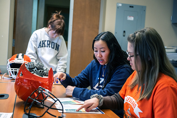Three students in the Cleveland Browns materials science of football class.