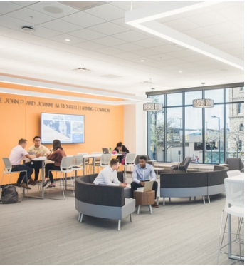 The second floor lobby of the Anthony J. Alexander Professional Development Center. Students enjoying the space by conversing with each other and studying.