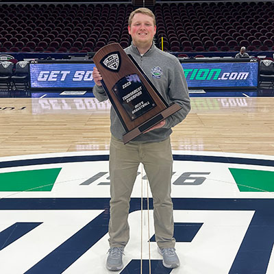 Josh Smith holding MAC Basketball Trophy