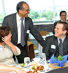 Dr. Calderon speaking with participants at a luncheon.