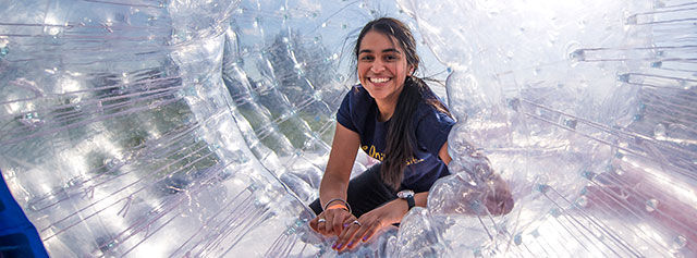 A student in a giant hamster ball at SpringFest