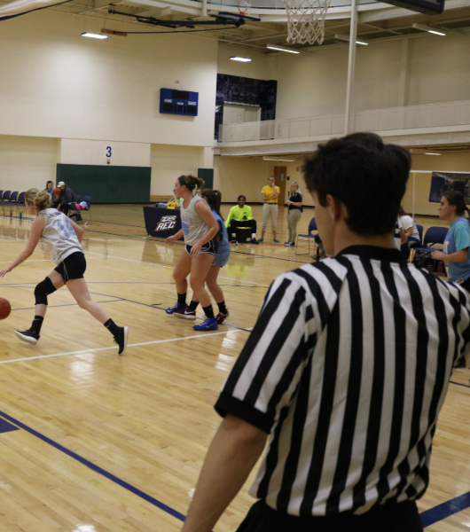 intramural sports official officiating a basketball game