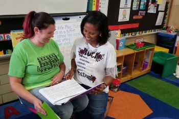 Literacy Coach, Rozlyn Grant, works with an Akron public pre-school teacher
