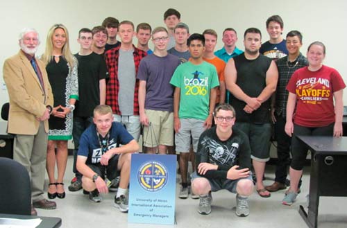 Emergency management and homeland security students gather for a group photo with their professors.