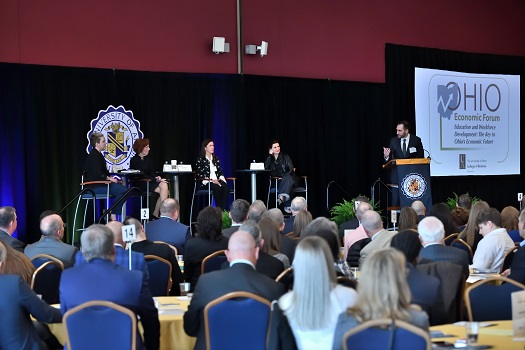 Dr. Michael DeDad, Assistant Professor, Economics, moderates the panel discussion