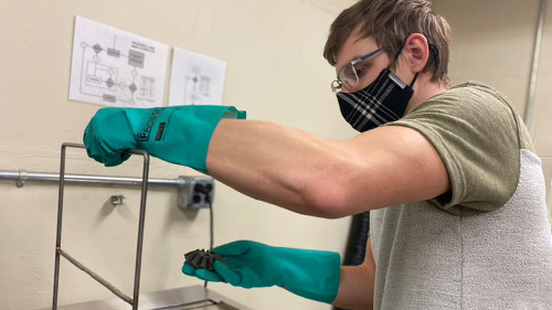 An engineering student works in a research center lab.