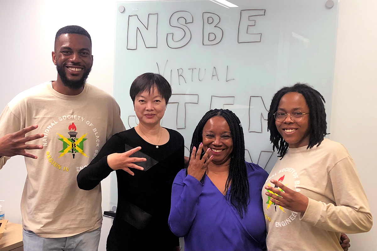 Bamidele Oluwadare, Dr. Julie Zhao, Dreama Whitfield, and Mia Jones making the “4” sign, representing the Region IV Student Chapter of NSBE.