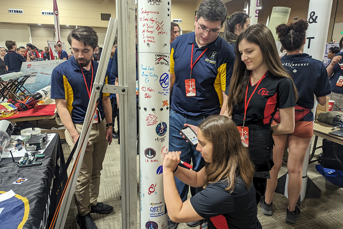 Students from the Cornell Rocket Team signing Imperium VI.