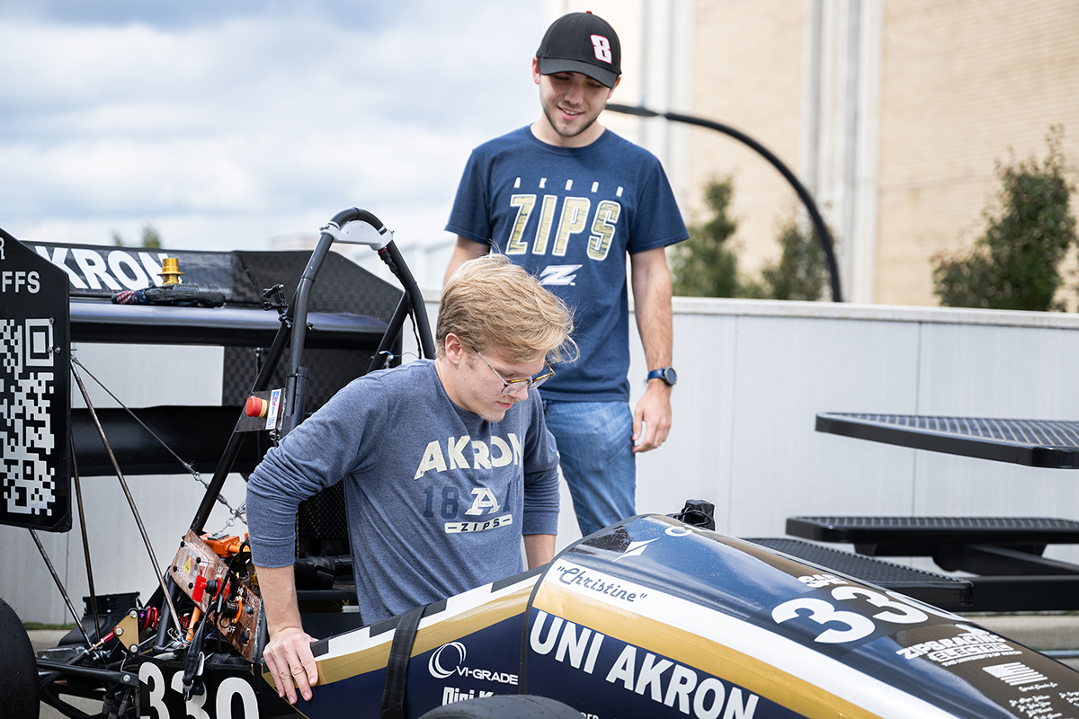 Zips Racing Electric students show off their car.