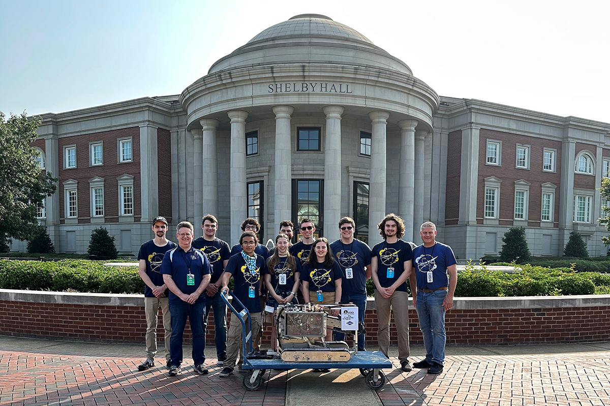 The members of The University of Akron's NASA Mining Robotics Team stand outside Shelby Hall, located on the University of Alabama's campus.