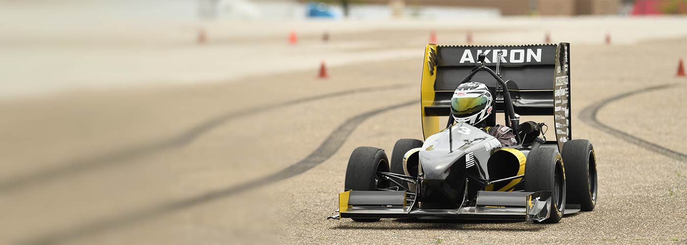A student-designed race car on the track