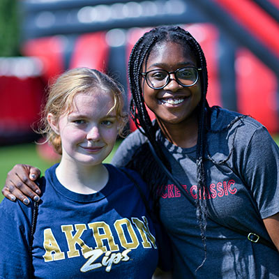 Two student enjoying an outdoor festival at UA.