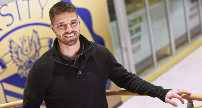 A graduate student in the lobby of UA's engineering building