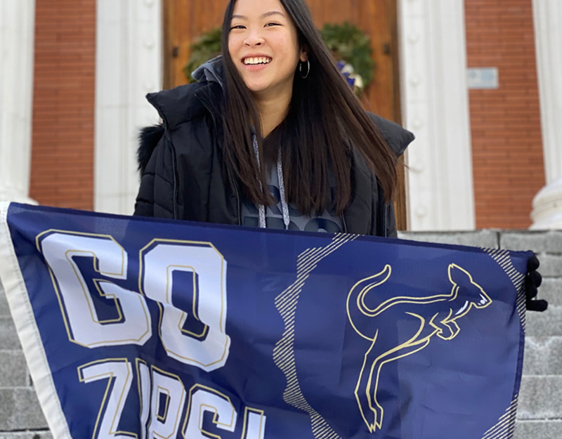 UA student holding a Go Zips flag