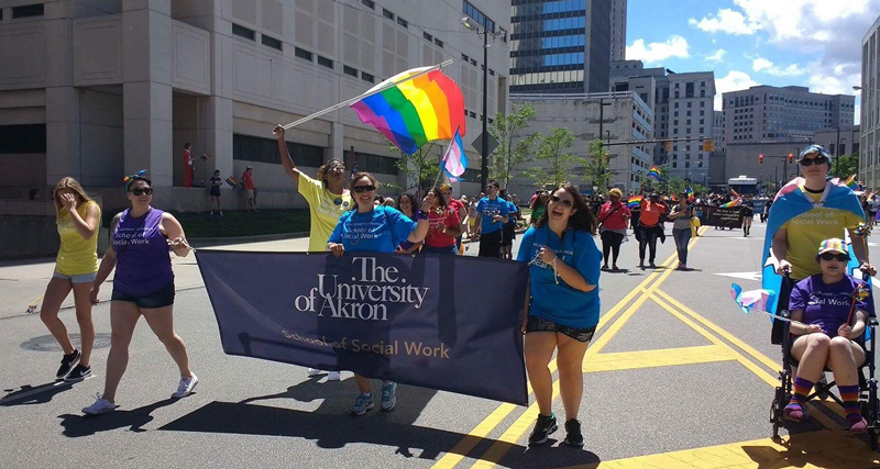 Students participate in the PRIDE parade in downtown Akron