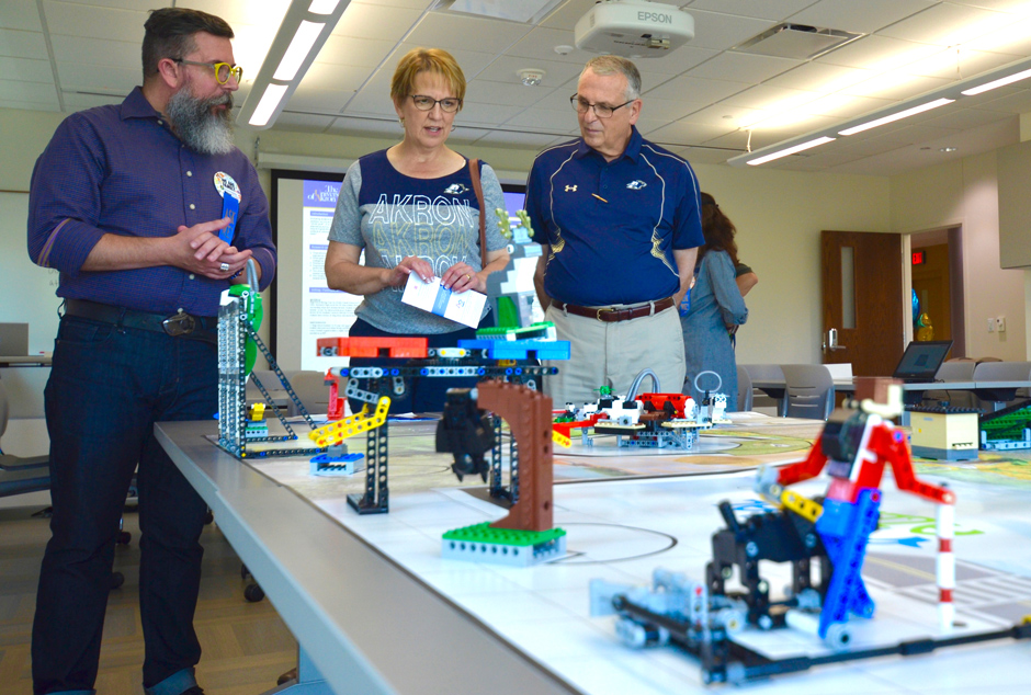 A professor explains a delay during the education school's open house