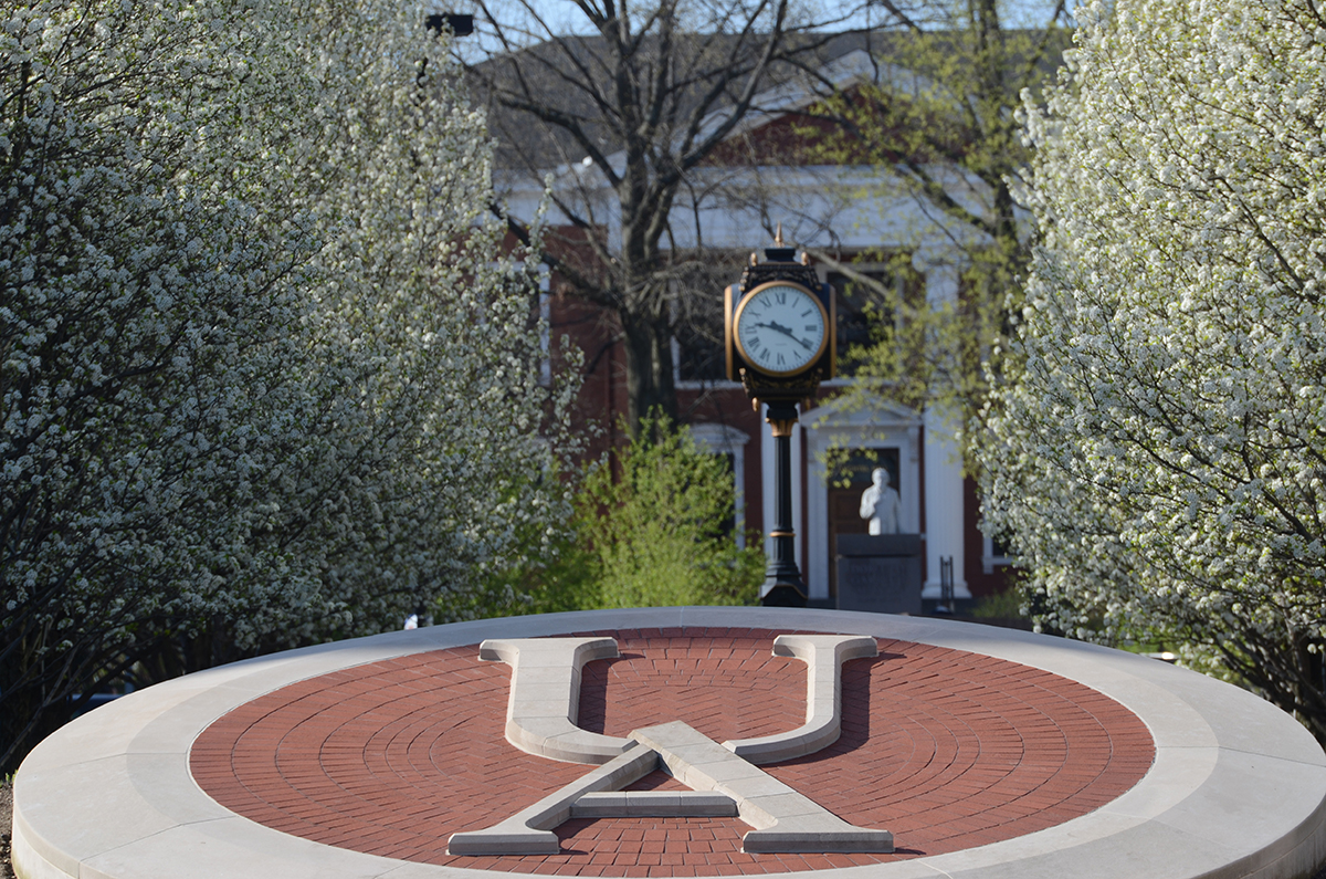A decorative UA etched in stone outside on a spring day