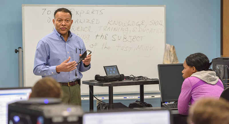 A cybersecurity professor leads a class