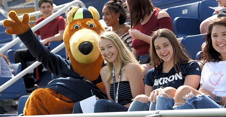 Zippy welcomes a new student to The University of Akron