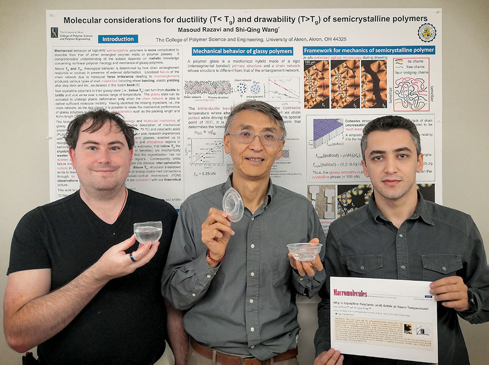 Scientists from The University of Akron hold a plastic cup that withstands boiling