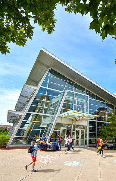 Students walk by the Student Union on a sunny summer day