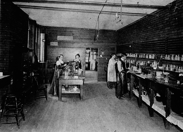 Graduate students completing a chemistry lab in Crouse Gym