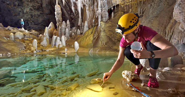 Dr. Hazel Barton inside a cave conducting research