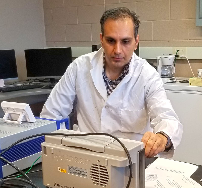 A researcher in a white coat working in a laboratory at The University of Akron