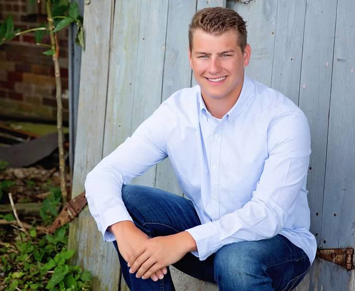 Joey Esker sitting near a barn