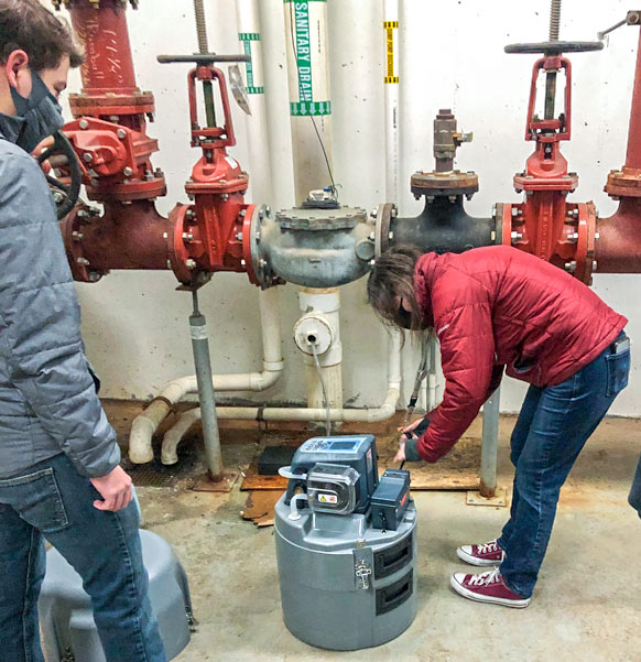 UA undergrad student researchers collect samples of waste water in the Exchange Street apartments