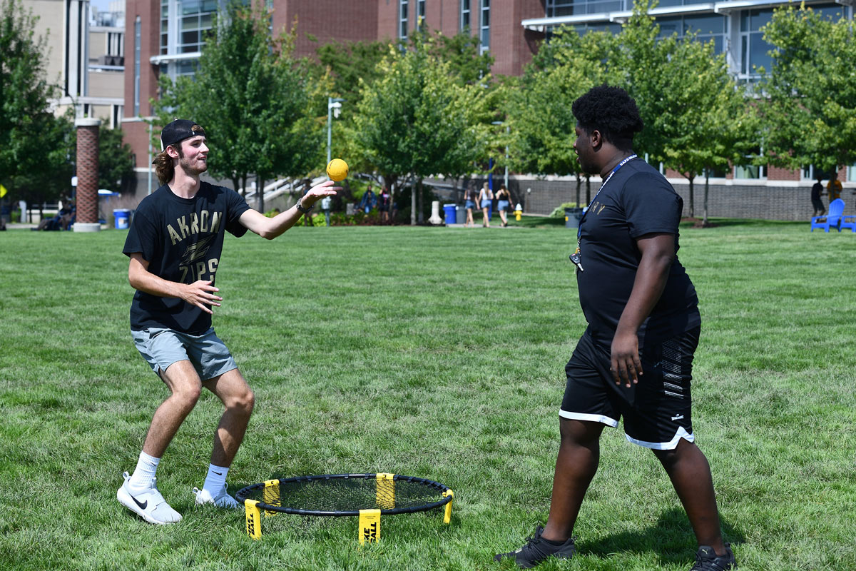 Two students play a game in Coleman Common