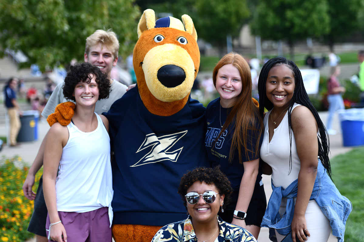 Zippy poses with students