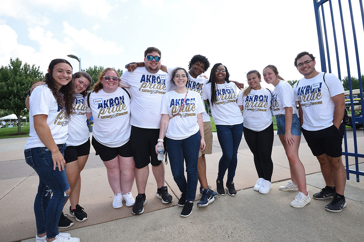 Student greeters stand in a line at the soccer stadium