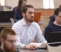 An Akron Law student in an academic class