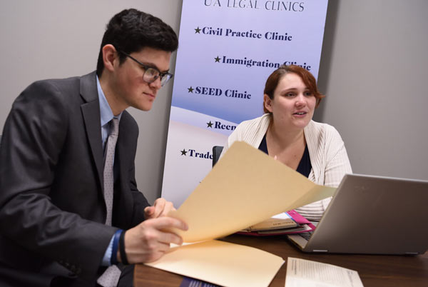 A law student with her supervisor meeting with a business client