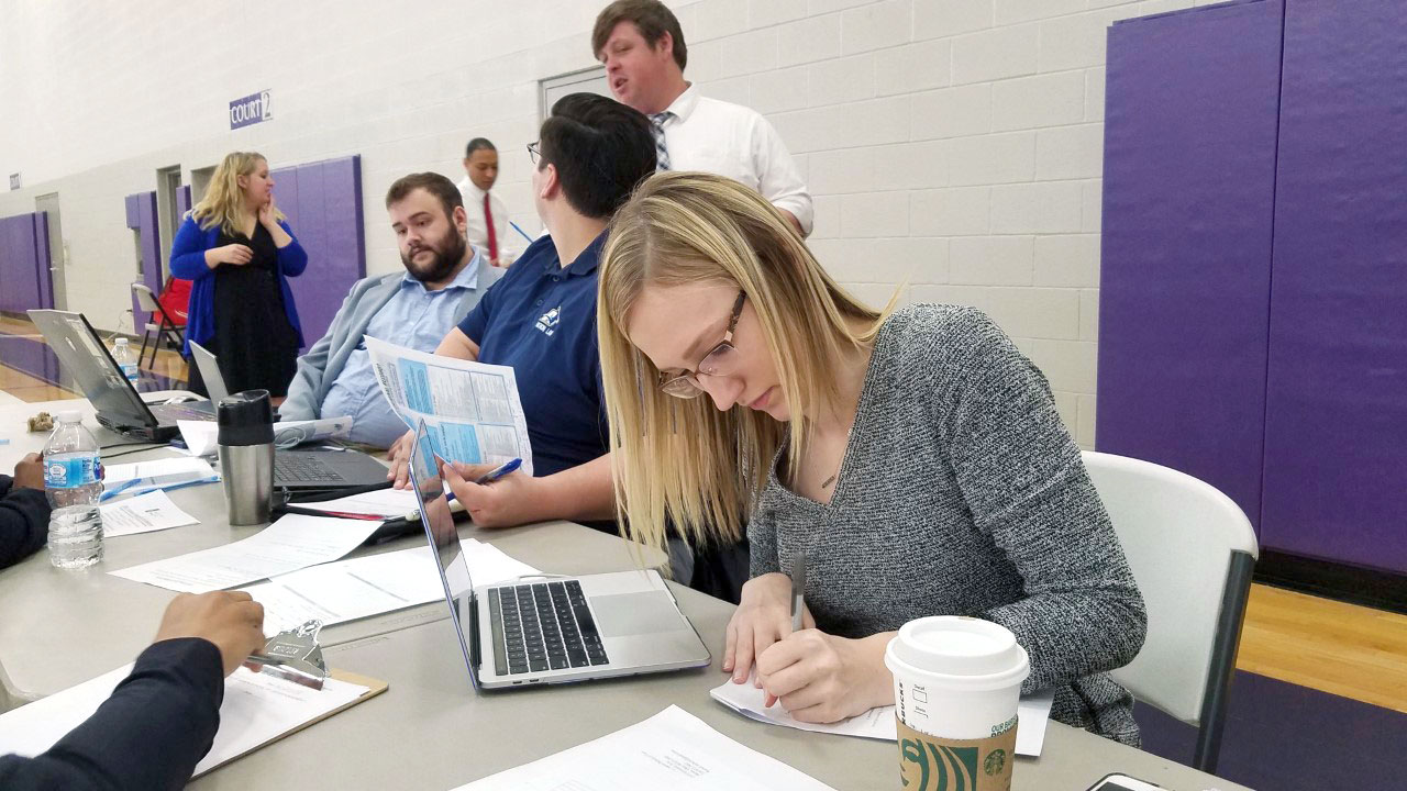 An Akron law student helps a client at a reentry clinic event in the city.