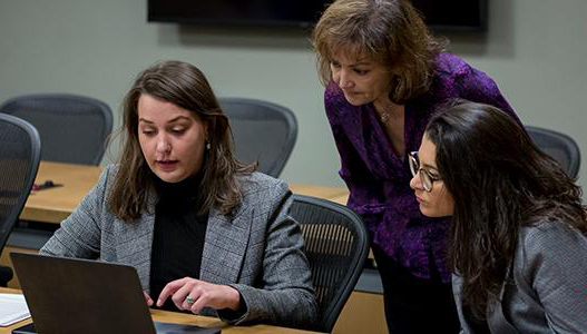 Emily Morris assisting two students