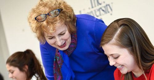 A College Credit Plus student at The University of Akron talks with a faculty member about an assignment