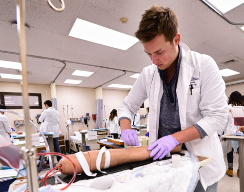 University of Akron nursing student works in a lab