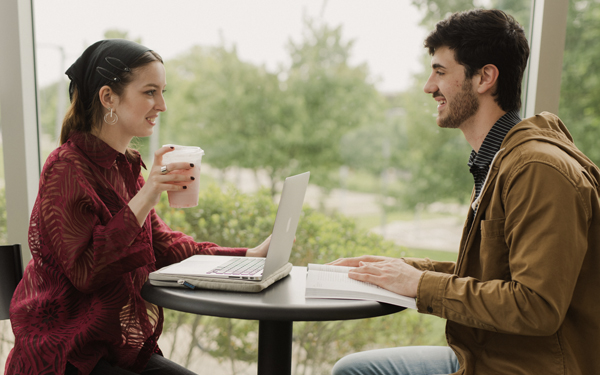 Two students talking over coffee