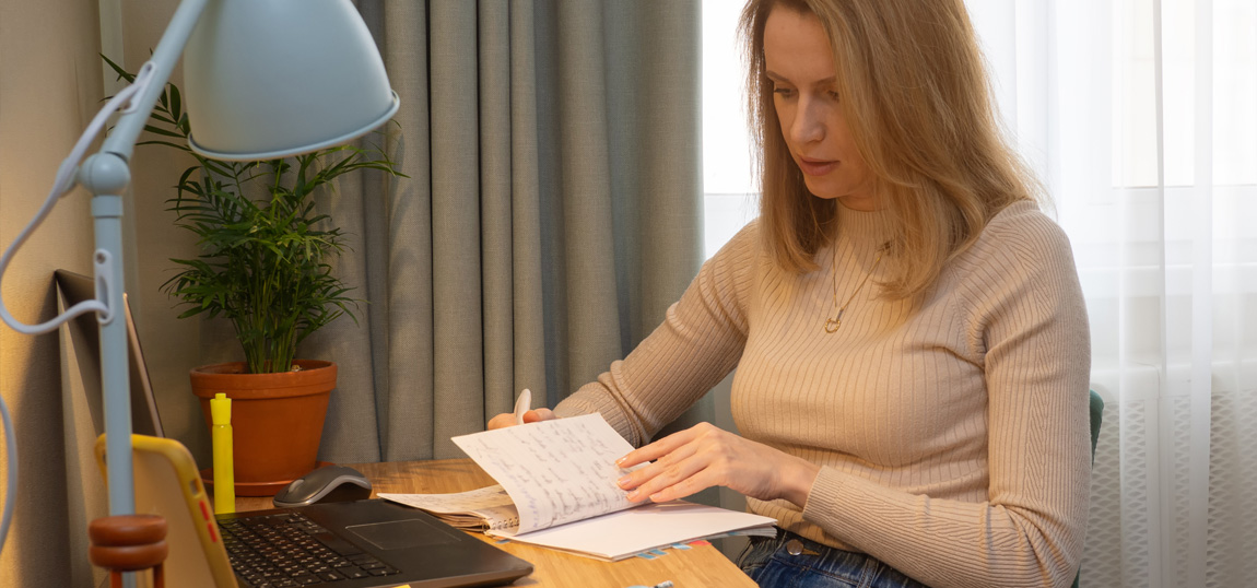 A student studying at a desk in her home