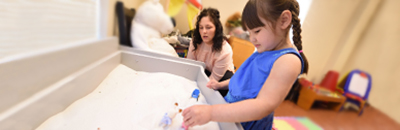 A PhD student working with a child in the clinic connected with the school of counseling at the university of akron.